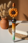 Terracotta-orange flower beaded pen in warm earthy home setting