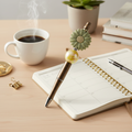Sage green flower beaded pen styled on a chic desk with a planner, coffee, and elegant stationery accessories
