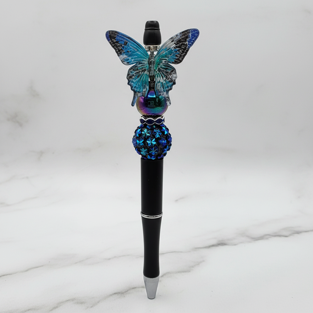 Teal and black butterfly beaded pen clean product shot on elegant background