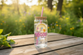 16oz Glass Tumbler Best Mom Ever with ice water and lemon slice on rustic picnic table