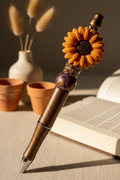 Terracotta-orange flower beaded pen in warm earthy home setting