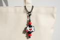 Beaded charm on white bag