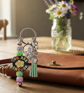 "You Are Enough" Beaded Keychain next to a brown leather purse on a farmhouse table